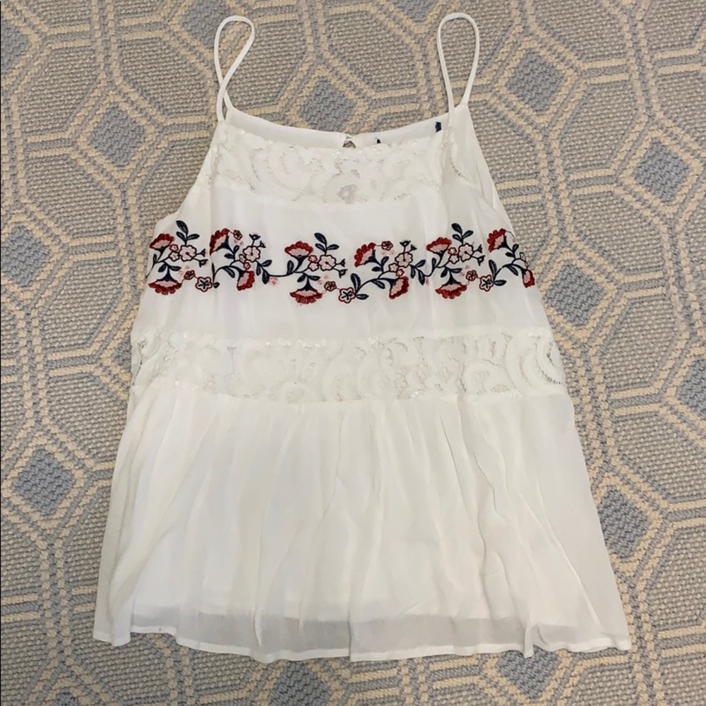 White spaghetti strap top with flower detail